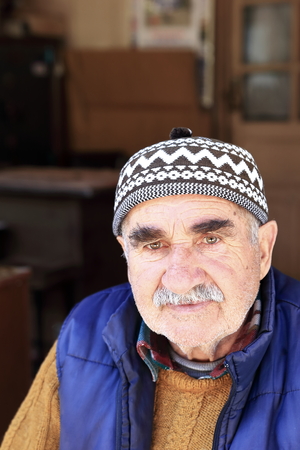 ELMALITURKEYAPRIL 05 2015: Local merchant watches the tourist sitting at the door of his business on April 05 Turkey.のeditorial素材