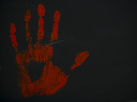 gouache drawing bloody handprint on a black backgroundの写真素材