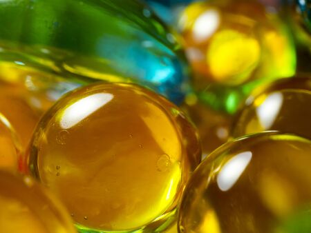 yellow glass beads with blue glass stone look edible and delicious macro close-upの写真素材