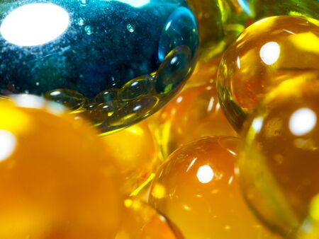 yellow glass beads with blue glass stone look edible and delicious macro close-upの写真素材