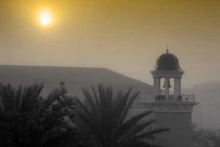 Early morning fog over the bell tower の素材