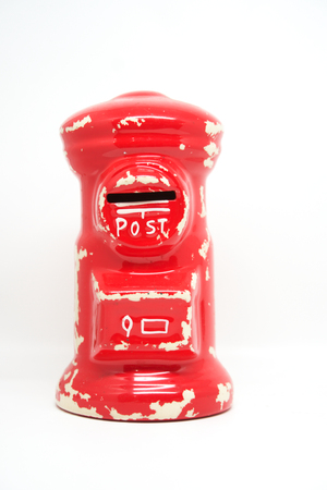 red post ceramic toy on white isolated backgroundの写真素材