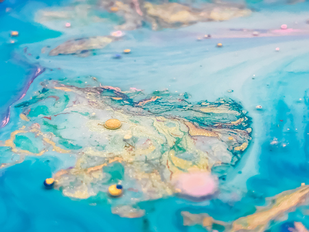 Abstract colorful bubbles marble background with milk oil and soap. Colored acrylic react to a drop of liquid soap in the oil. Christmas background.の写真素材