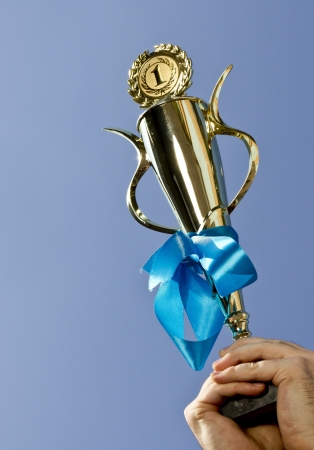 1st place winner cup in hands の写真素材