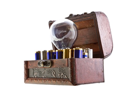 Batteries energy for an idea concept shot. Opened treasure chest with batteries and and a bulb lamp...