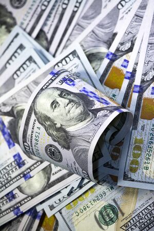 Franklin Portrait Close-up with curved hundred dollar bill on dollars background