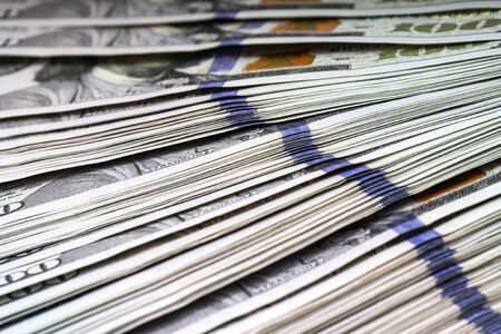 Pile of US dollars money background. Macro close up.