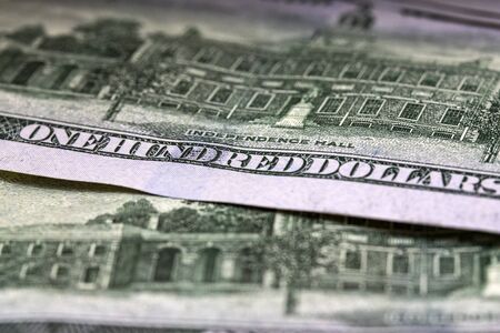 Dollar macro. One hundred dollars sentence visible. Macro close up detail photo. One hundred dollar...