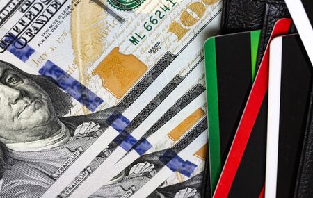 Credit cards and dollars in cash. Close-up macro view.の写真素材