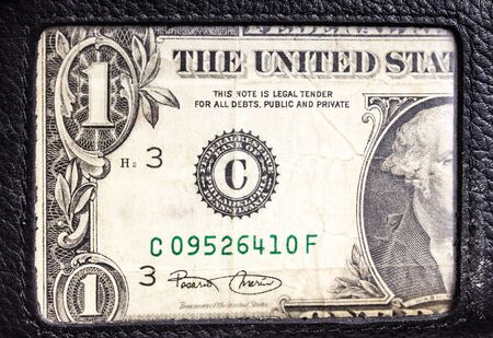 One dollar in wallet macro close up