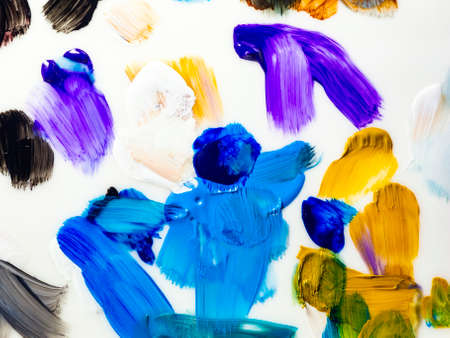 Colored paint strokes closeup closeup on white background.