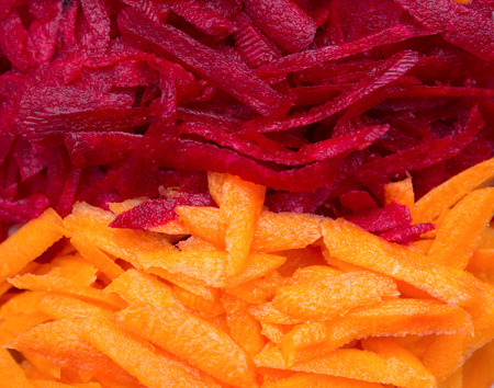 The concept of healthy eating. Shredded carrots and beets, the photo is divided into two halves vertically,background, close-upの写真素材