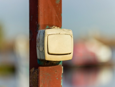 electric switch, an off switch, hanging on a pole on the street, Sunny dayの写真素材