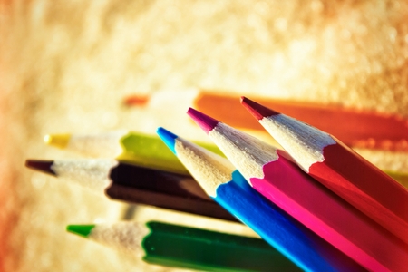 Scattered on the beach in the sand colored wooden pencils for drawingの写真素材