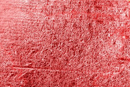 Abstract light red Golden background of crumpled aluminum foil. Can be used for design as a background. red textureの写真素材