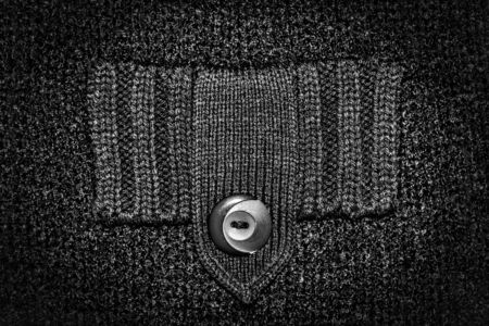 Black knitted caused by the product. Button-down pocket. The concept of a rainy day, lack of money....
