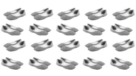 A set of variations of angles of women's summer shoes made of fabric in white and blue stripes, ballet flats, different perspectives, isolated on a white background. The concept of women's shoes. B W toning.の写真素材