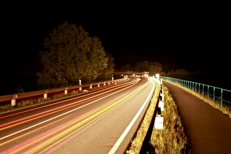 street in the night with driving carsの写真素材