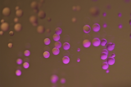 some pearls with colored lights on a mirrorの写真素材