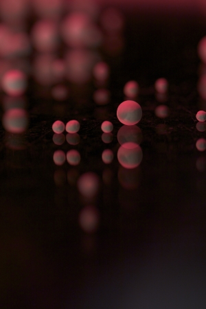 some pearls with colored lights on a mirror