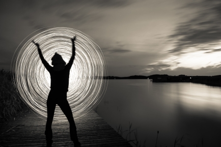 a women in the sunset who play a light gameの写真素材