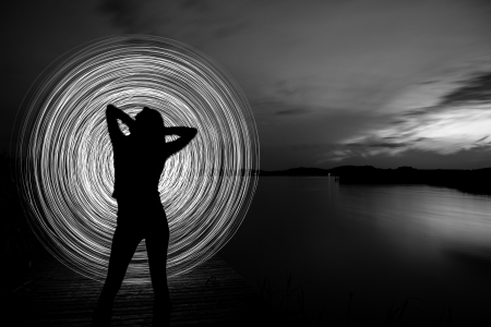 a women in the sunset who play a light gameの写真素材