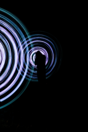 a men make a light show in the nightの写真素材