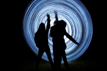 people make a light show in the night