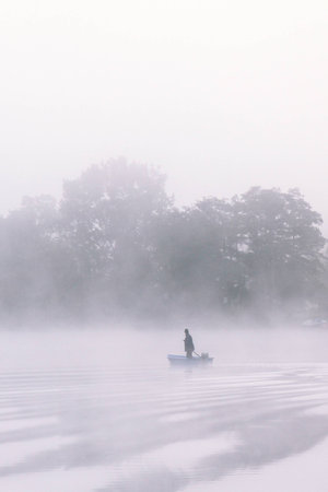 a lake bank on a foggy october morningの写真素材