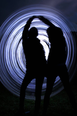 people make a light show in the nightの写真素材