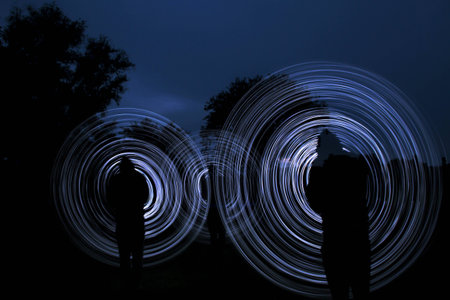people make a light show in the nightの写真素材