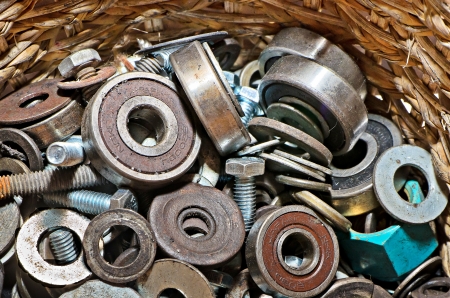 hardware - bolts, nuts, washers, screws in wooden bucketの写真素材