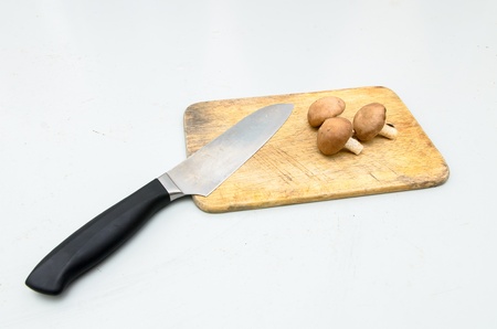 Fresh Shiitake Mushrooms and chopping knife on chopping block
