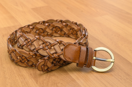 Brown women belt on wooden floorの写真素材