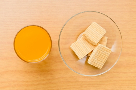 Orange juice and Wafer on the wooden tableの写真素材