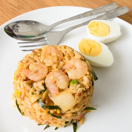 Khow Pat Tom Yum Koong  - Stir fried spicy rice with herbs and prawns serving with boiled egg ,thai foodの写真素材