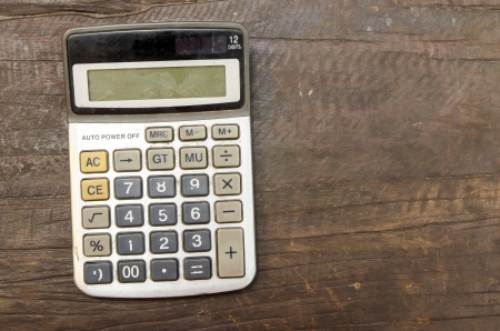 The Old calculator on wooden tableの写真素材
