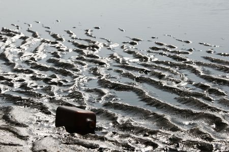Empty bottle on sea coast.