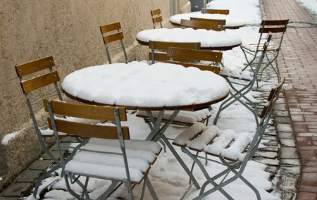 snowy chairs in street cafeの写真素材
