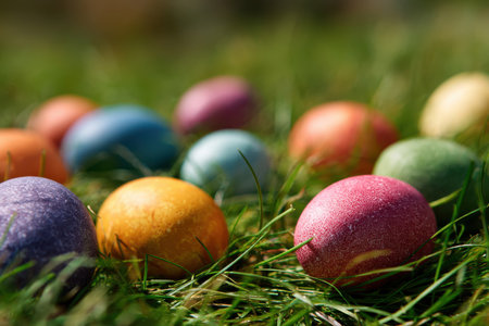 Colorful easter eggs hidden in vibrant green grass for cheerful spring festivities and delightful holiday decor optionsの素材