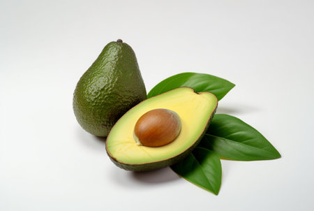 avocado with cut in half and leaves isolated on white background. generative aiの素材