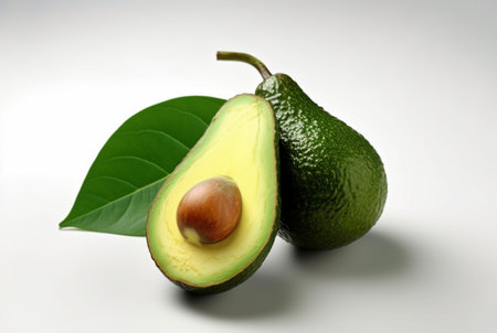avocado with cut in half and leaves isolated on white background. generative aiの素材