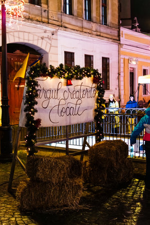Rasnov Christmas Market Stalls and Crowds Illuminated at Nightのeditorial素材