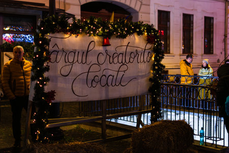 Rasnov Christmas Market Stalls and Crowds Illuminated at Nightのeditorial素材