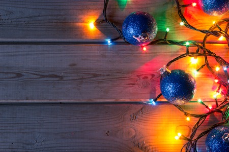 Christmas tree garland, Christmas tree branches and Christmas balls on wooden table mock upの写真素材