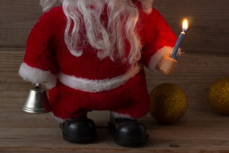 burning candle in hand of Santa Clausの写真素材