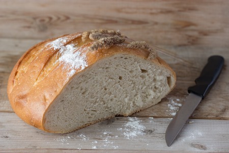fresh baked bread and ears on wooden table