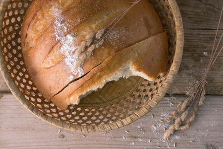 fresh baked bread and ears on wooden table