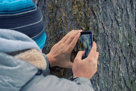 man take pictures with his mobile phoneの写真素材