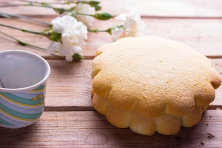 cookies on wooden table with pink and white flower